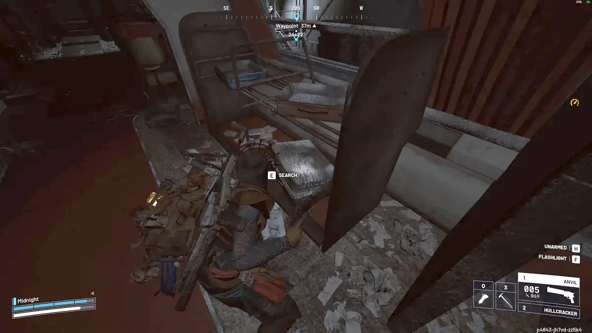 Raider searching a case under a bunk in a dark sleeper train compartment