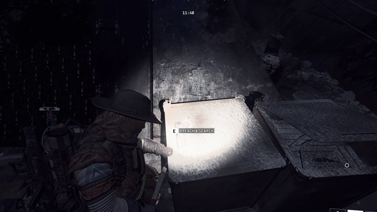 Raider breaching a metal crate lit by a flashlight